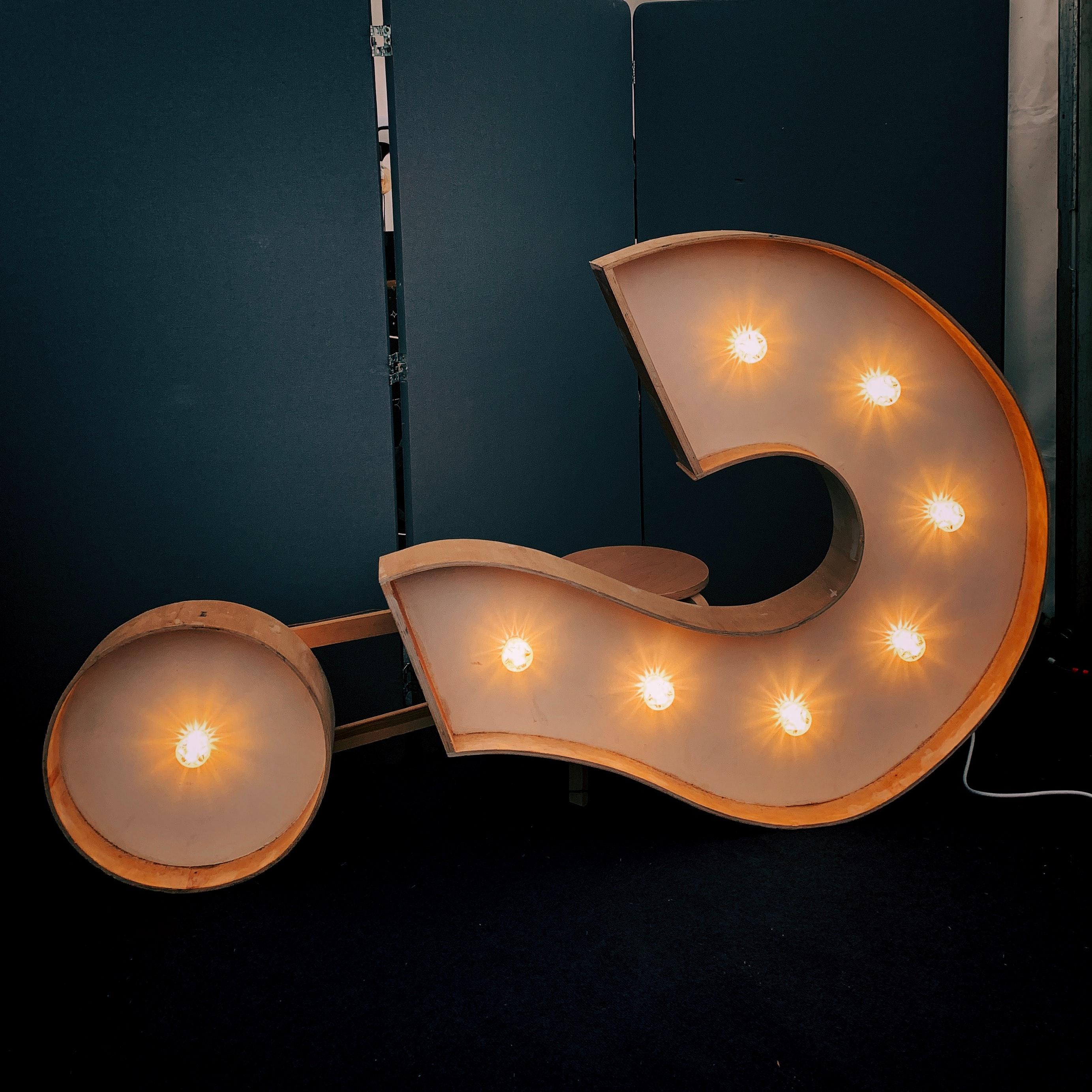 Large question mark sign with lights in the centre